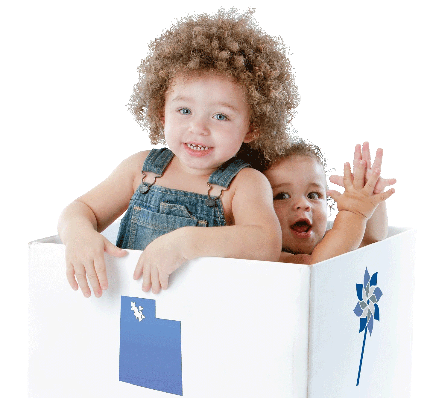 Young children smiling and playing in a box